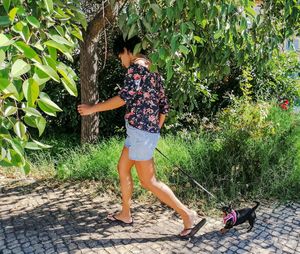 Full length of woman standing on footpath