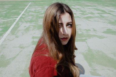 Portrait of young woman on footpath