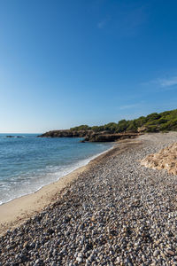 Scenic view of beach against blue sky