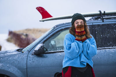 Woman surfer portrait with frozen surfboard