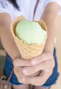 Close-up of hand holding ice cream
