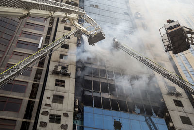 Low angle view of firefighters fighting fire