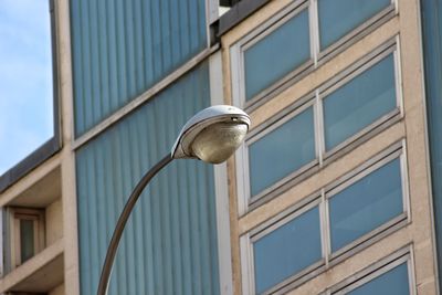 Low angle view of street light against building