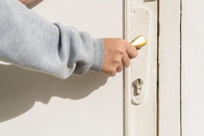 Close-up of human hand on door