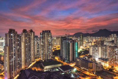 High angle view of illuminated buildings against sky at sunset