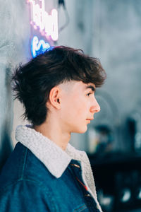 Teenager posing with denim jacket and cool hairstyle