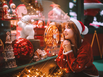 Portrait of young woman standing in store