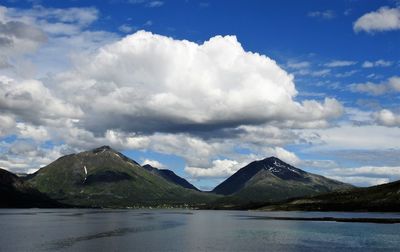 Scenic view of lake and mountains against sky