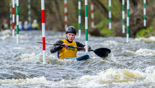 Portrait of young man kayaking in river