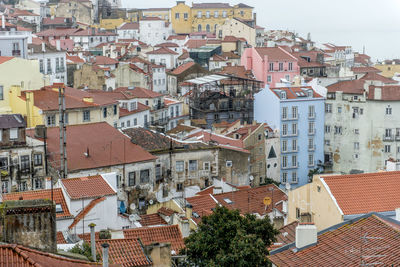 Old town of lisbon with densely packed houses, roofs and backyards from an elevated vantage point.