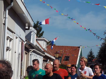 Group of people in building against sky