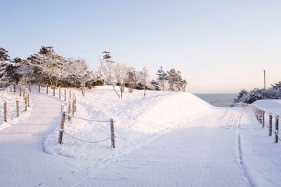 Snow covered field against sky