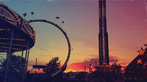 Low angle view of illuminated ferris wheel against sky