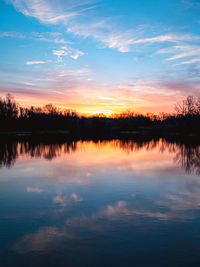 Scenic view of lake against sky during sunrise 