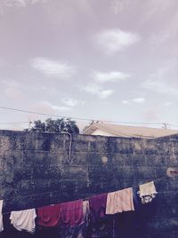 Low angle view of clothes drying against sky