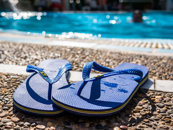 Close-up of shoes on beach