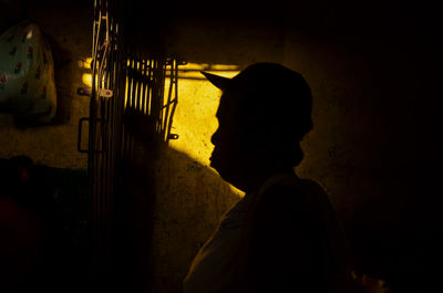 Close-up of silhouette woman by wall