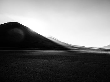 Scenic view of arid landscape against clear sky