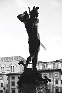 Low angle view of woman against clear sky