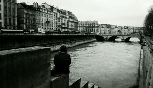 Rear view of bridge over river in city