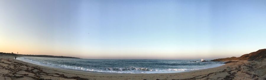 Scenic view of beach against clear sky