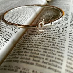 Close-up of bracelet on open book