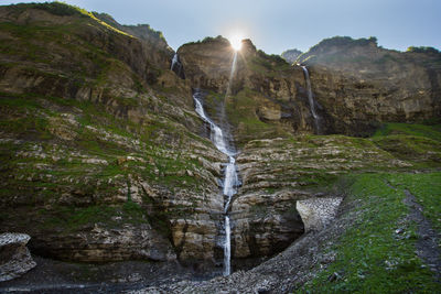 Scenic view of waterfall falling from mountain