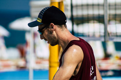 Portrait of young man looking at swimming pool