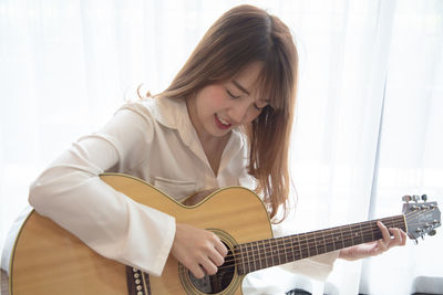 Young woman playing guitar