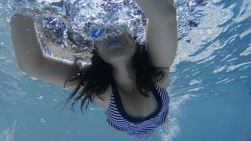 Portrait of young woman in water