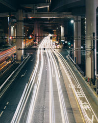 Light trails on road in city at night