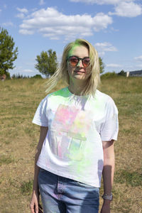 Portrait of young woman standing on field