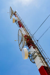 Low angle view of telecommunications tower against sky