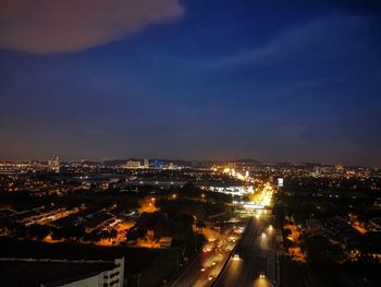 High angle view of illuminated buildings against sky at night