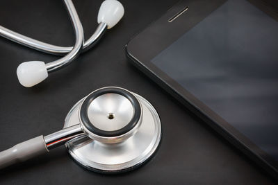 Close-up of stethoscope with phone on table