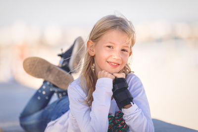 Portrait of smiling girl lying down