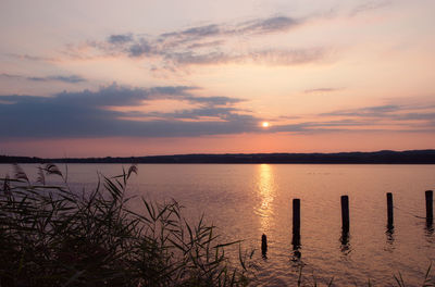 Scenic view of lake against sky during sunset