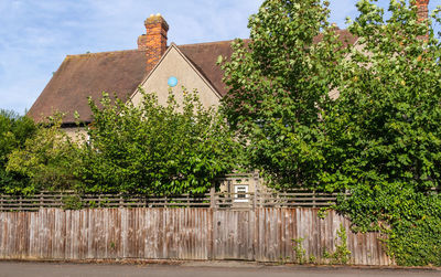 Exterior of old building by trees against sky