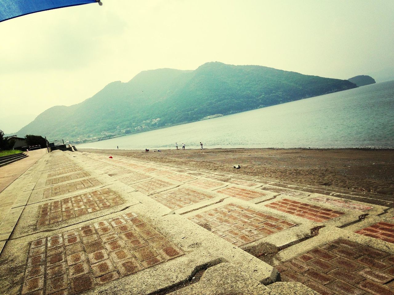 sky, mountain, tranquil scene, scenics, tranquility, sand, road, landscape, the way forward, beauty in nature, nature, transportation, beach, water, sea, incidental people, sunlight, day, remote, outdoors