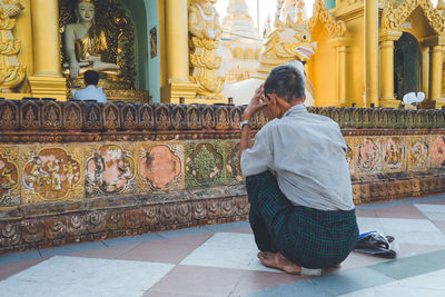 Rear view of people at temple outside building