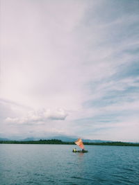 Sailboat on sea against sky