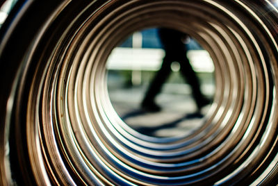 Low section of man seen through spiral metal