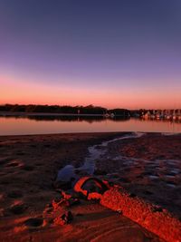 Panoramic view of the banks of a river at sunrise with rustic pipes running along the banks