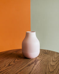 Close-up of red teapot on table
