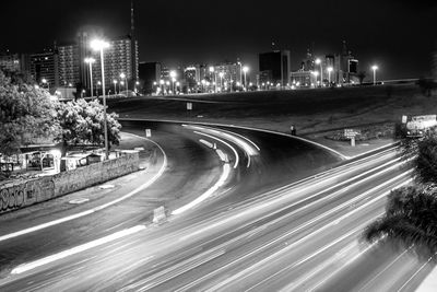 Light trails on road in city at night