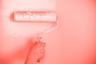 Close-up of hand holding pink wall
