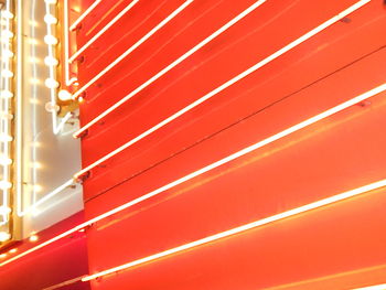 Full frame shot of illuminated neon lights against orange wall