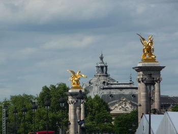 Low angle view of statue against cloudy sky