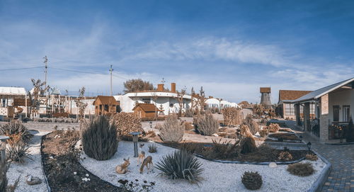 Houses and buildings in city against sky