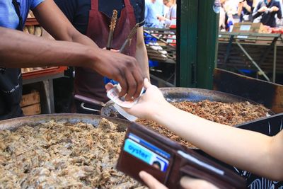 Midsection of man working at market stall